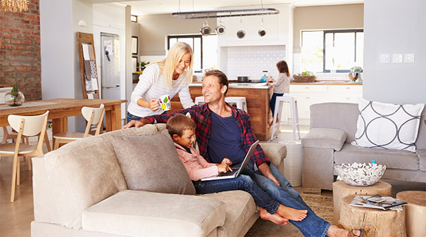 Family at home looking at the SEER calculator on their laptop